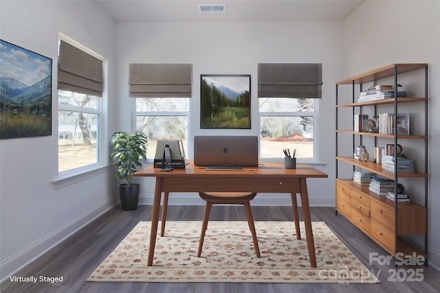 home office with dark wood-style floors, visible vents, and baseboards