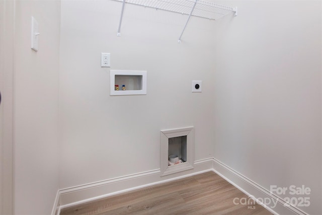 clothes washing area featuring hookup for an electric dryer, laundry area, washer hookup, wood finished floors, and baseboards