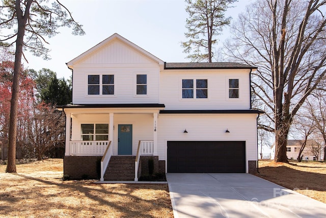 view of front of home featuring a garage, a porch, concrete driveway, and stairs