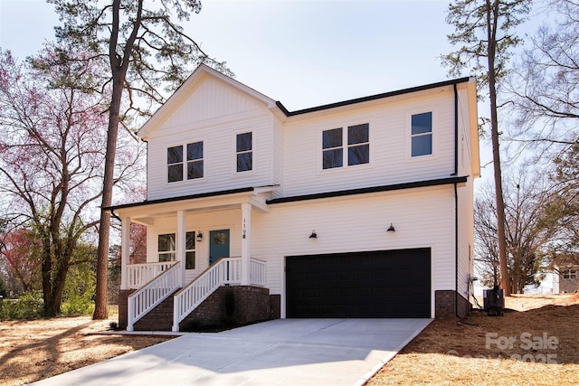 view of front of home featuring covered porch, an attached garage, and concrete driveway