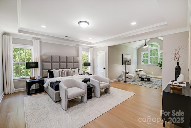 bedroom featuring a tray ceiling and multiple windows