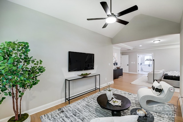 living area featuring lofted ceiling, baseboards, ceiling fan, and light wood finished floors