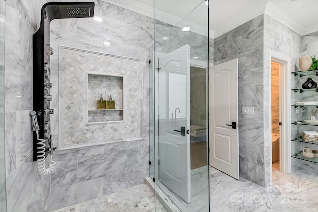 full bath with tile walls, marble finish floor, crown molding, and a shower stall