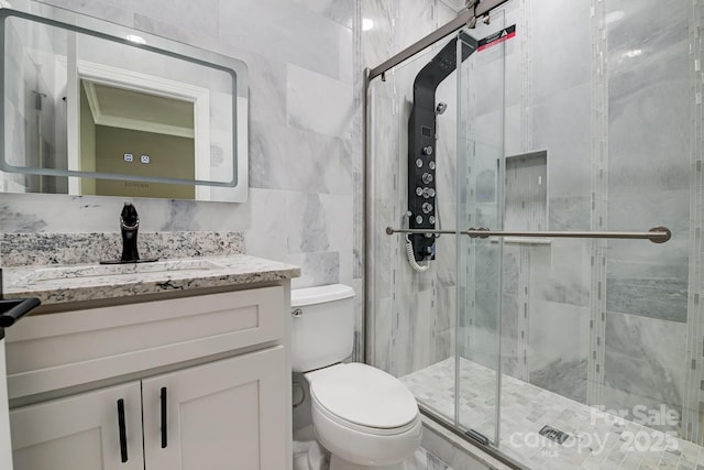 full bathroom with toilet, a stall shower, tile walls, and vanity