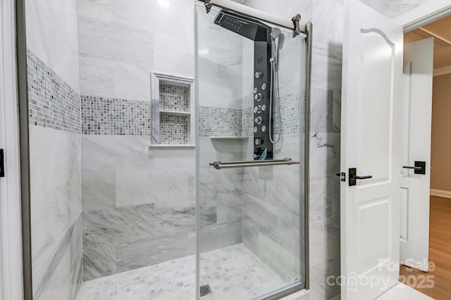 full bath featuring a stall shower and wood finished floors