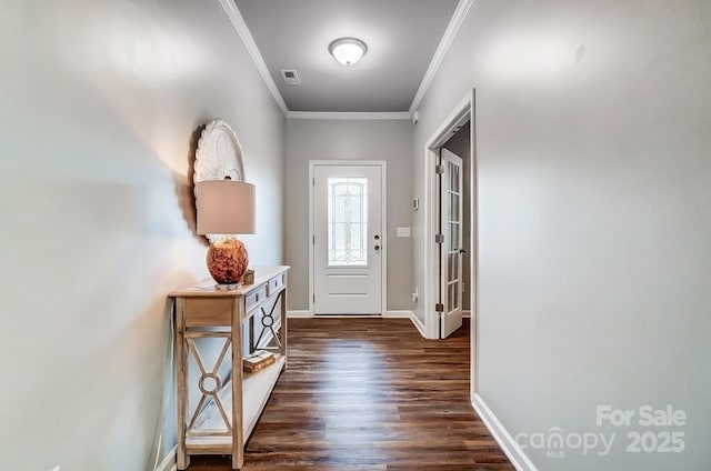 doorway featuring baseboards, dark wood-style flooring, visible vents, and crown molding