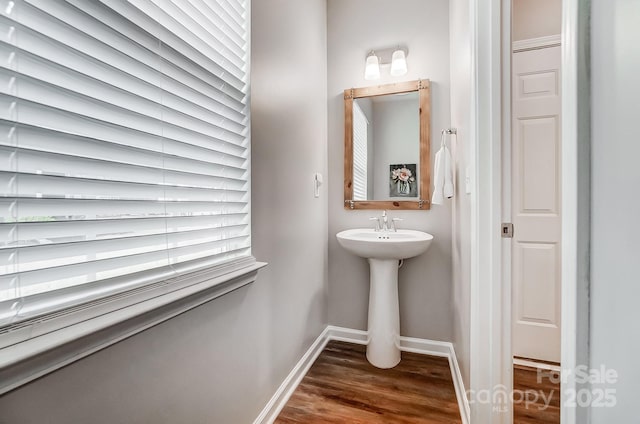 bathroom with baseboards and wood finished floors