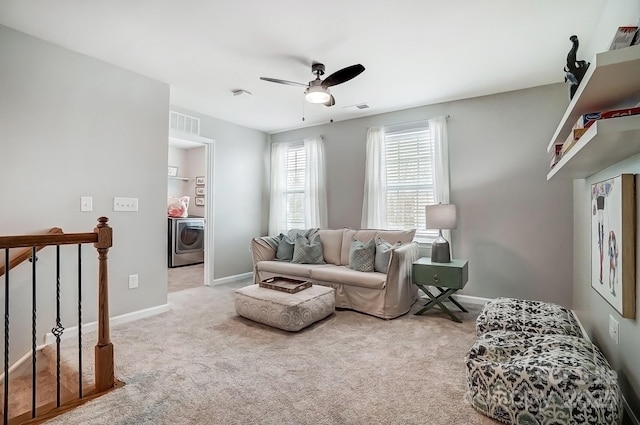 carpeted living area with washer / clothes dryer, visible vents, ceiling fan, and baseboards