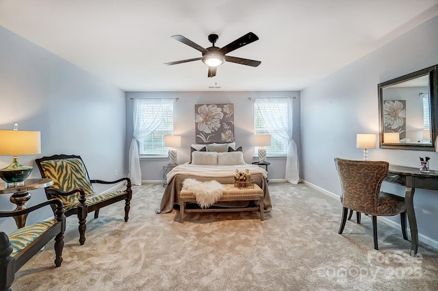 bedroom featuring baseboards, a ceiling fan, and light colored carpet