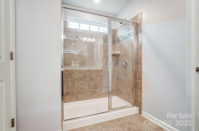 full bath with a stall shower and tile patterned floors