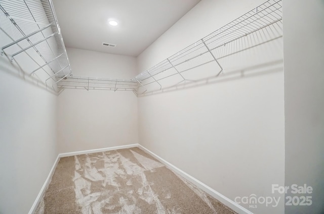 walk in closet with carpet floors and visible vents