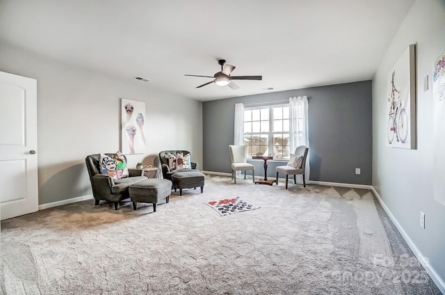 sitting room with a ceiling fan, visible vents, baseboards, and carpet flooring