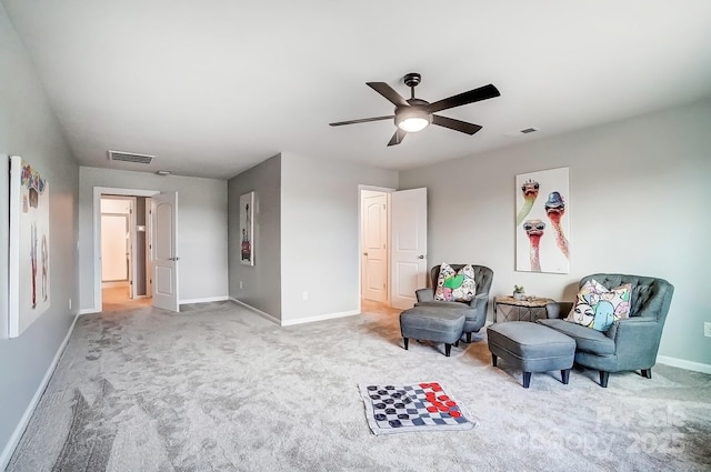 sitting room featuring carpet floors, visible vents, ceiling fan, and baseboards