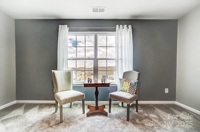 living area with baseboards, visible vents, and carpet flooring