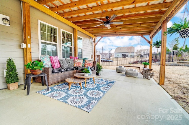 view of patio / terrace featuring ceiling fan, a trampoline, fence, and a residential view