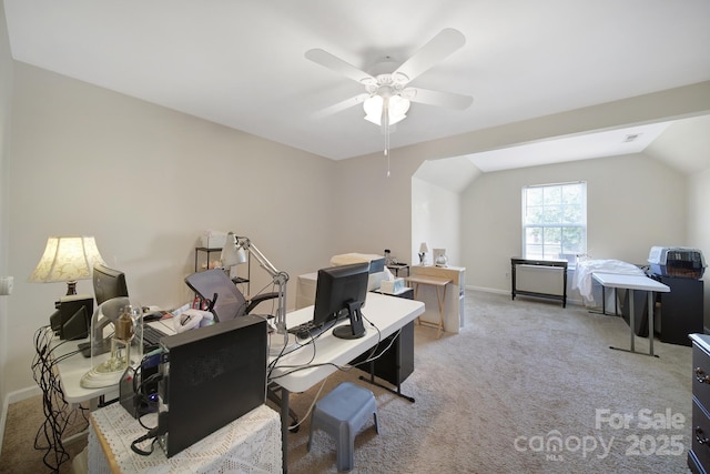 office featuring lofted ceiling, ceiling fan, baseboards, and light colored carpet