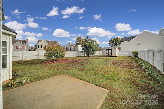 view of yard featuring a patio area, a fenced backyard, a residential view, and a storage unit