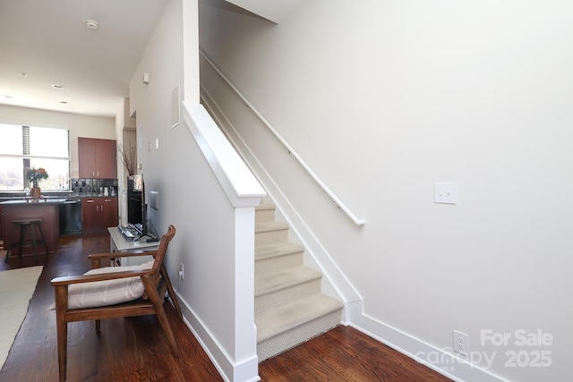 stairs with baseboards and wood finished floors