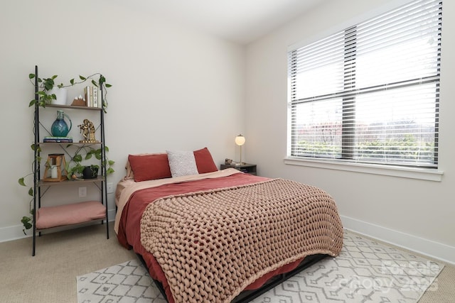 bedroom with baseboards and carpet flooring