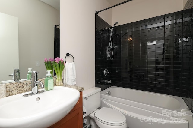 bathroom featuring tub / shower combination, vanity, and toilet