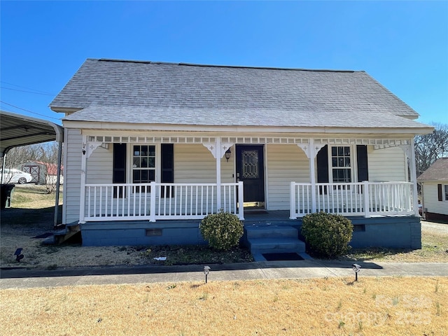 bungalow-style home featuring a porch, a detached carport, crawl space, and roof with shingles