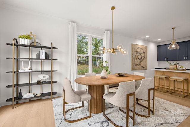 dining room with recessed lighting, a chandelier, crown molding, and light wood finished floors