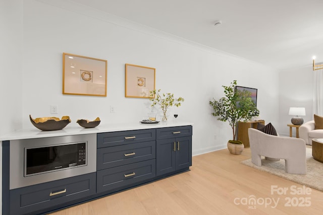 interior space featuring crown molding and light wood finished floors