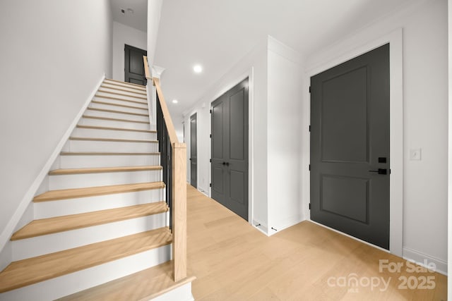 stairs featuring recessed lighting, wood finished floors, and baseboards