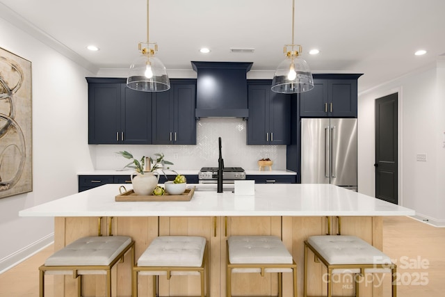 kitchen featuring visible vents, appliances with stainless steel finishes, a kitchen bar, and premium range hood