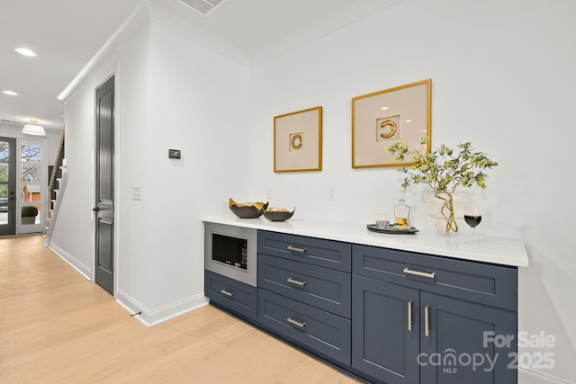 hall with ornamental molding, recessed lighting, light wood finished floors, baseboards, and stairs