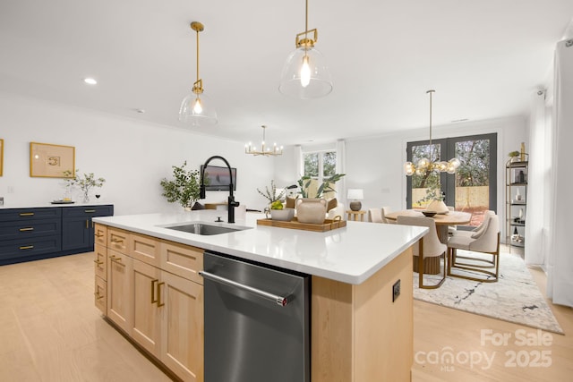 kitchen with light brown cabinetry, a notable chandelier, dishwasher, and a sink