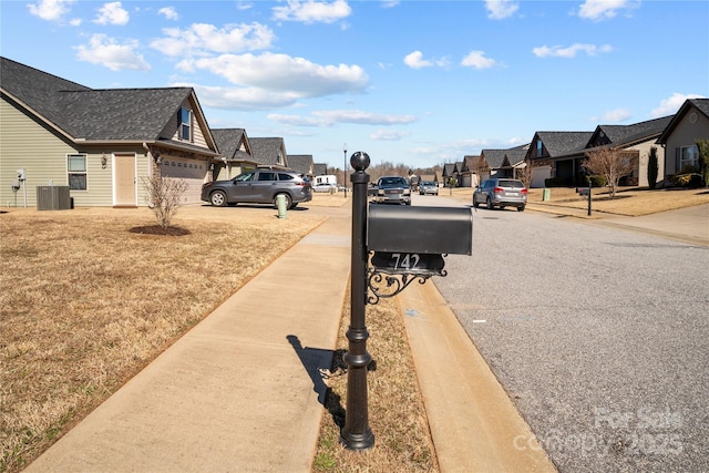 view of street with sidewalks, a residential view, and curbs