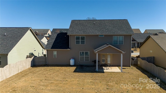 back of house featuring a patio area, a fenced backyard, and a yard