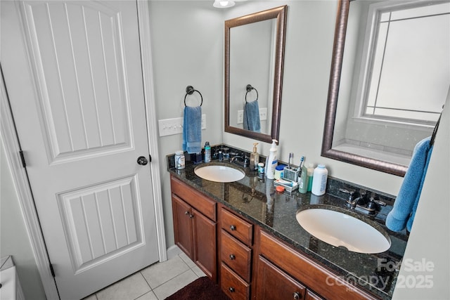 bathroom with double vanity, a sink, and tile patterned floors