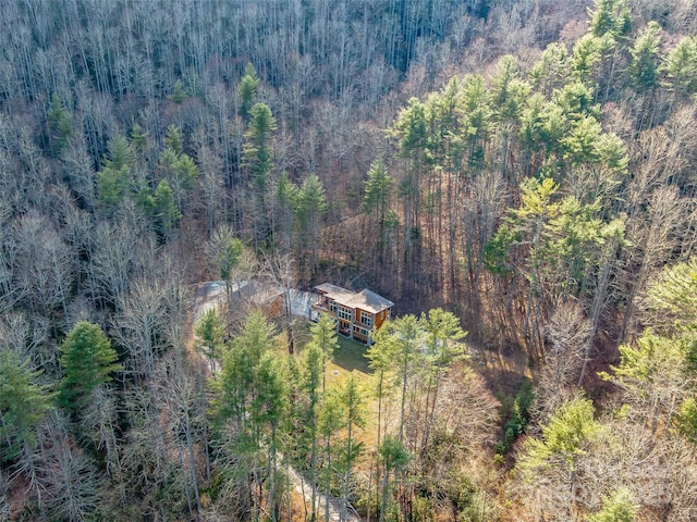 drone / aerial view with a wooded view