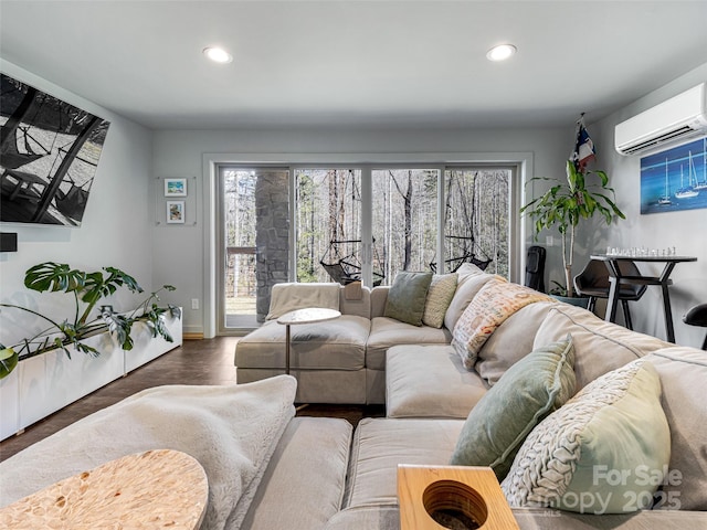 living room with plenty of natural light, a wall mounted air conditioner, wood finished floors, and recessed lighting