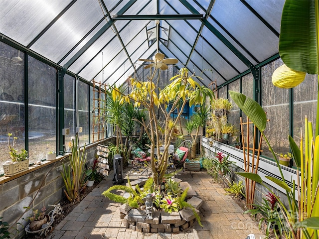 sunroom / solarium with a ceiling fan and lofted ceiling