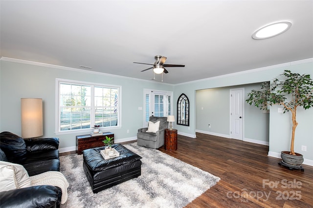 living area with dark wood finished floors, visible vents, ornamental molding, ceiling fan, and baseboards