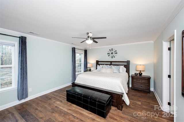 bedroom featuring multiple windows, ornamental molding, and dark wood finished floors