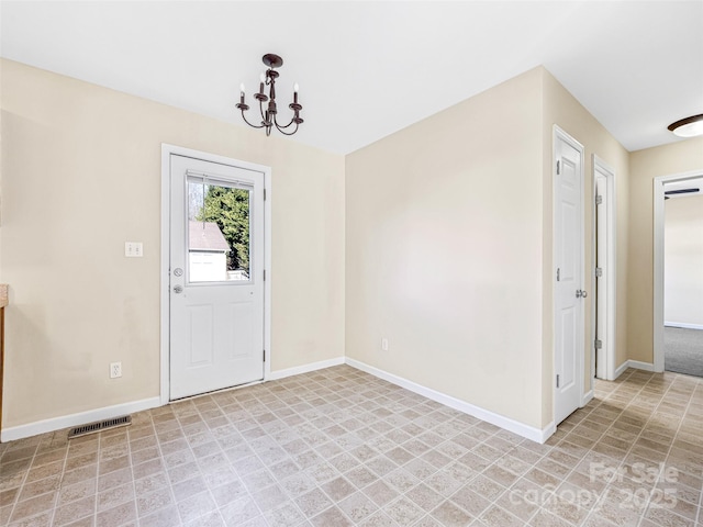 entrance foyer with baseboards, visible vents, and a chandelier