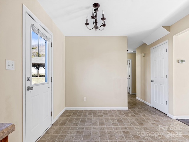 interior space with baseboards and a notable chandelier