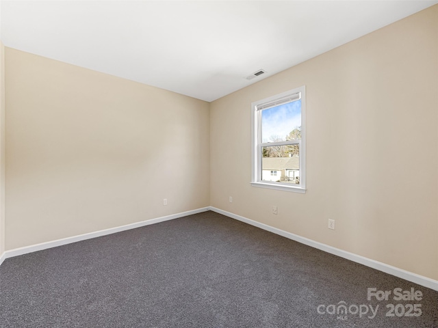 carpeted empty room with visible vents and baseboards