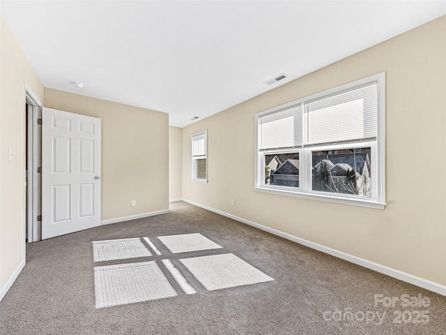 unfurnished bedroom with visible vents, baseboards, and carpet flooring