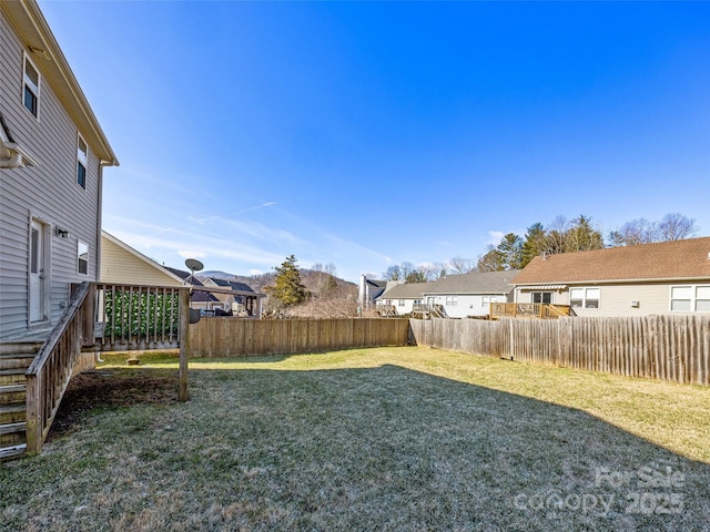 view of yard featuring a fenced backyard and a residential view