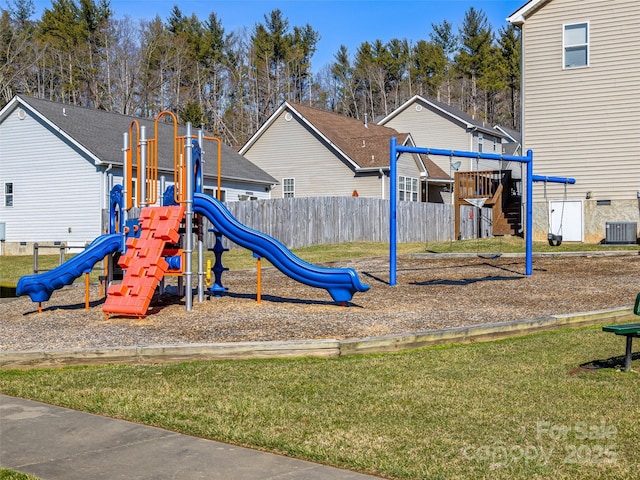 view of play area with fence, cooling unit, and a yard