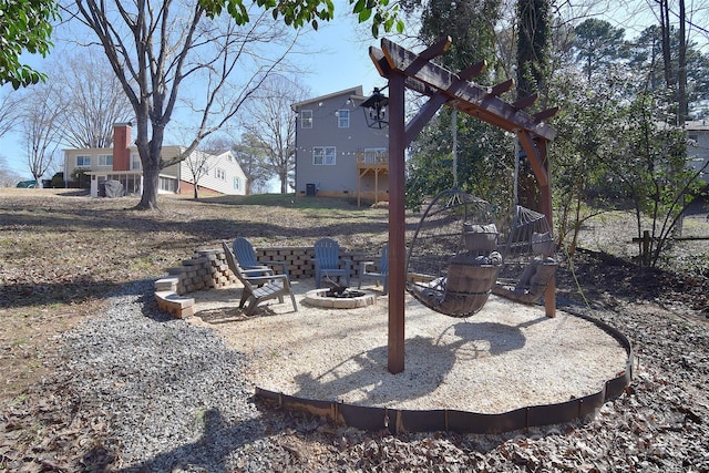 view of yard with a fire pit