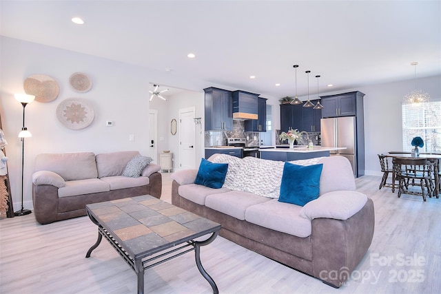 living area featuring light wood finished floors and recessed lighting