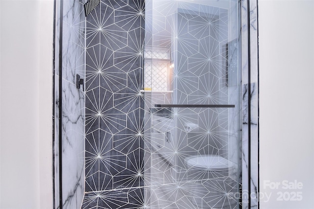 interior details featuring tiled shower