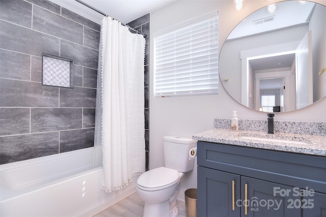 full bath with toilet, vanity, shower / bath combo with shower curtain, and visible vents