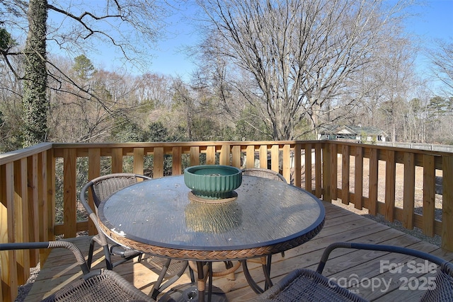 wooden deck featuring outdoor dining space